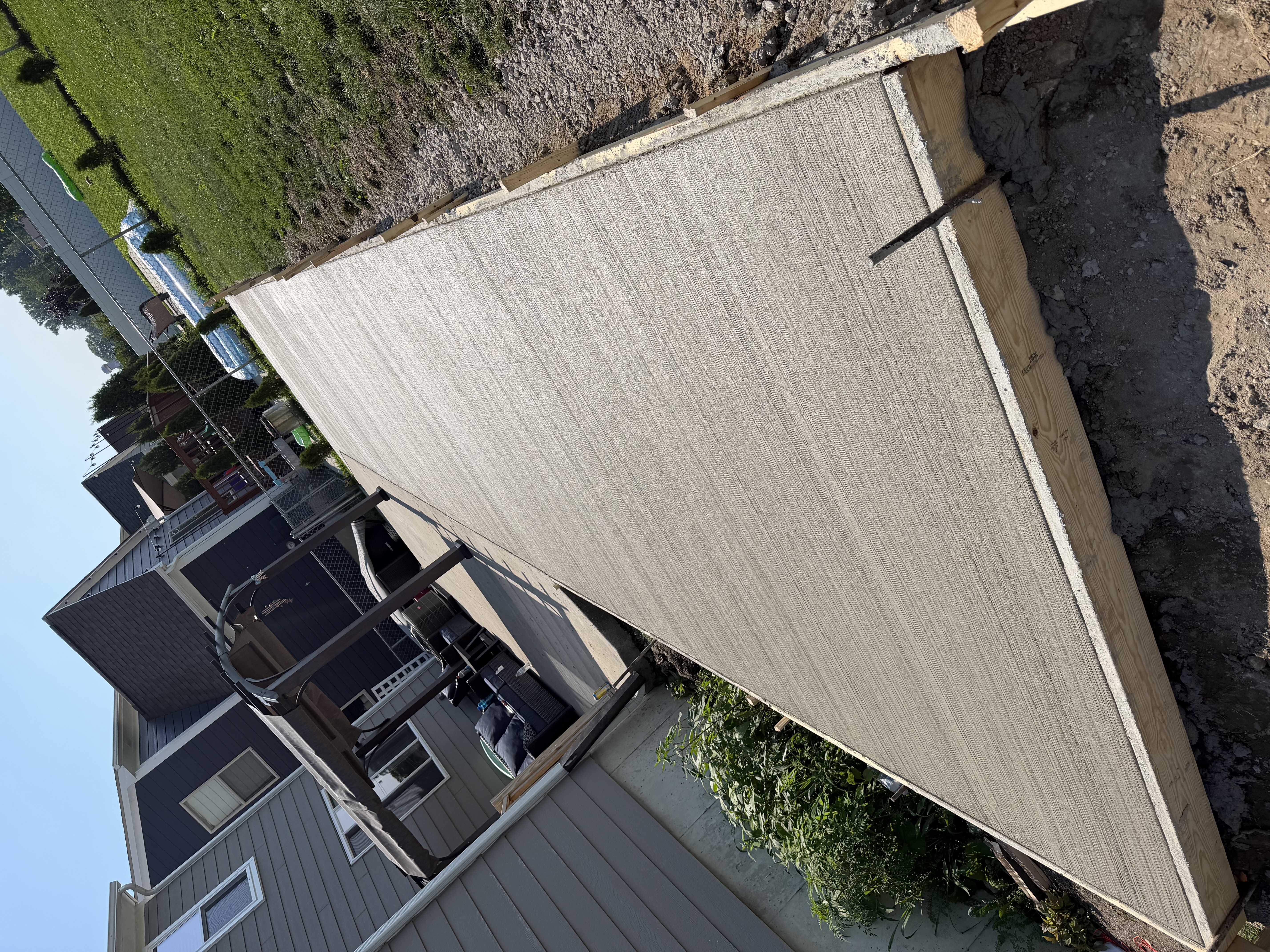 Backyard patio extension by Mitten Made Concrete