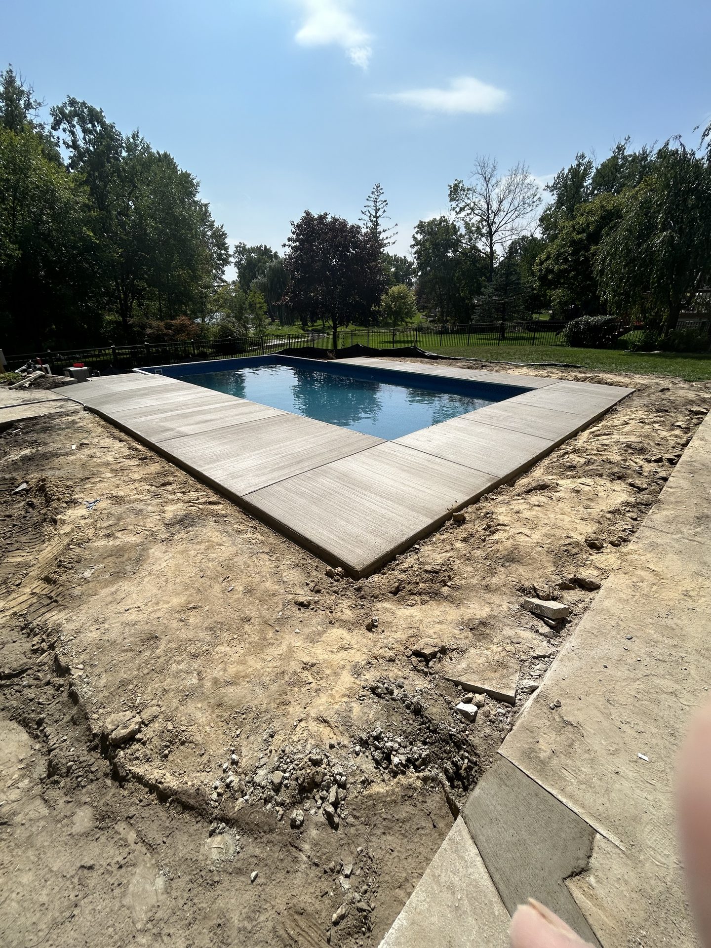 Concrete pool deck formed and poured in one day by Mitten Made Concrete